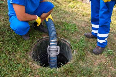 Professionnel débouchant des canalisations à l'aide d'un tuyau à haute pression